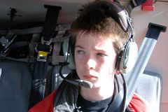 02 Peter Ryan In Helicopter As It Takes Off From Canmore Towards Mount Assiniboine In Winter.jpg